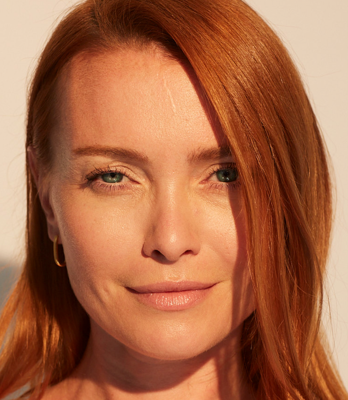 older woman smiling with a light glow on her skin